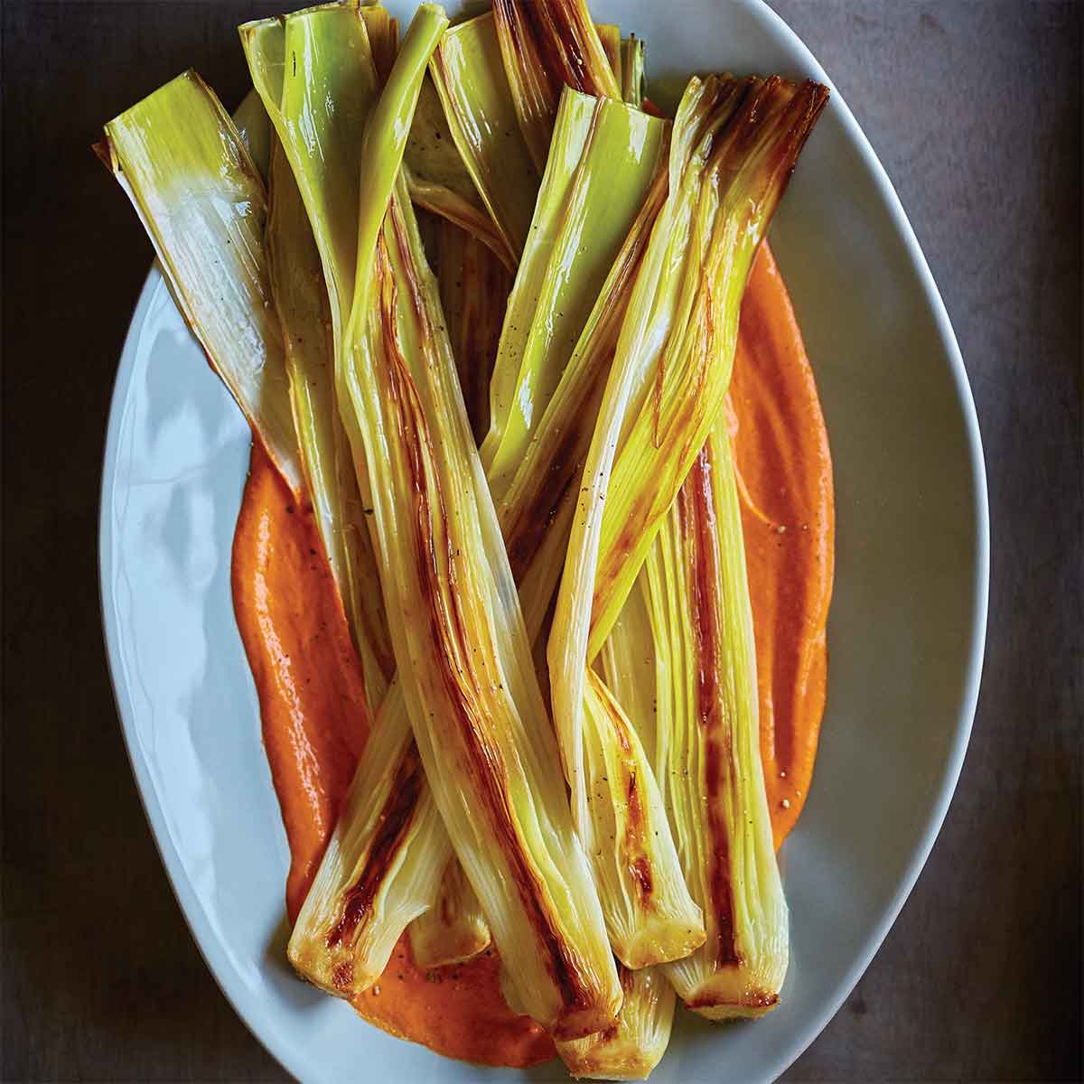 https://www.penguinrandomhouse.ca/sites/default/files/2019-08/Roasted-Leeks-Romesco-Sauce-Vegetables-First_0.jpg?height=225